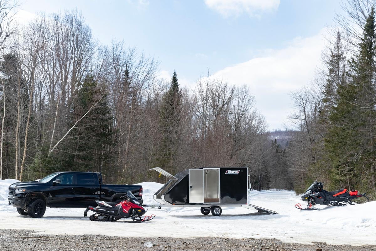 Triton Black TC Series With Two Red Snowmobiles